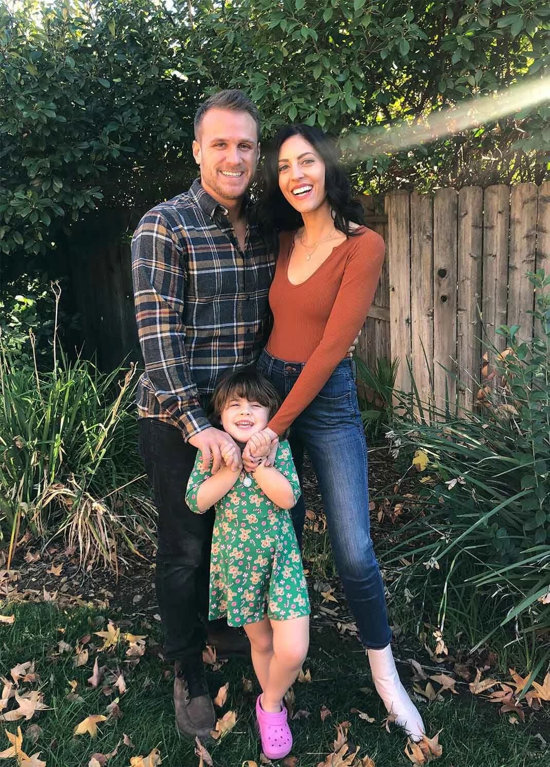 Nick, the owner of Divine Shine, with his family outdoors in their backyard